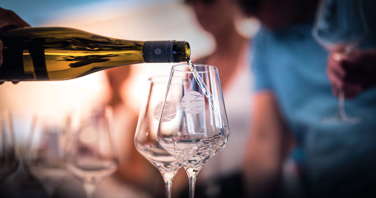 Wein wird ins Glas eingeschenkt